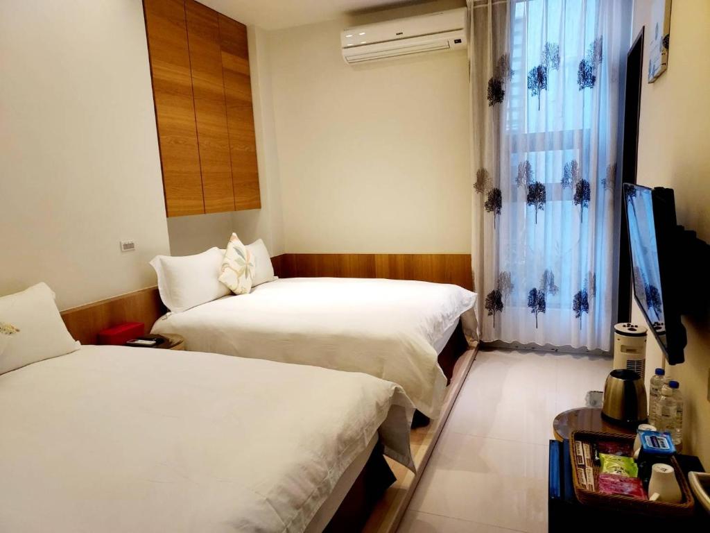 Postel nebo postele na pokoji v ubytování 野居海景渡假民宿Simple Life Home Stay