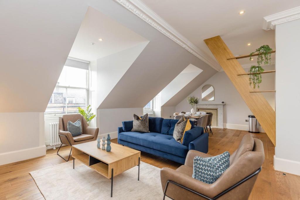 un soggiorno con divano blu e sedie di Dragon Suites - Ladon Suite - 2 bed city centre luxury apartment a Edimburgo