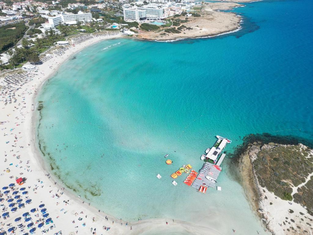 an aerial view of a beach with a cruise ship at Aktea Beach Village in Ayia Napa