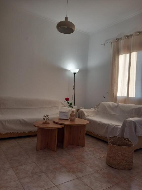 a living room with two beds and a table at Korali in Symi