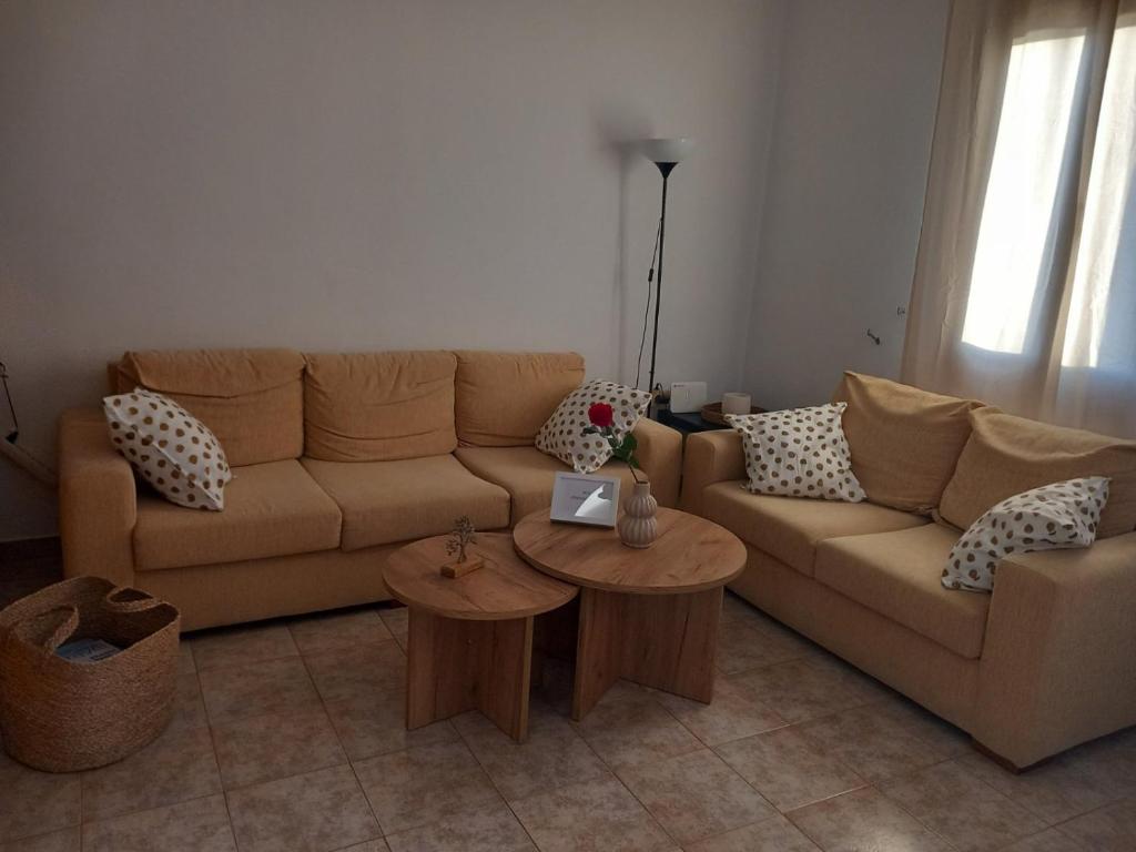 a living room with a couch and two tables at Korali in Symi