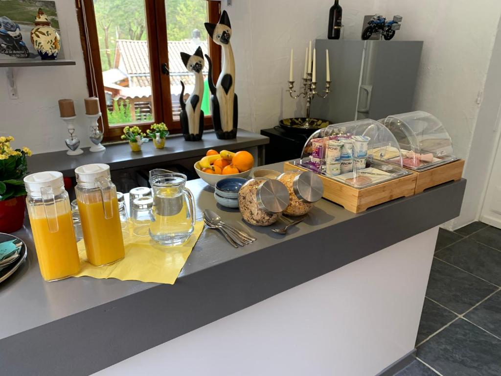 a kitchen counter with orange juice and a tray of food at Maison Castellane Chambre d&#39;Hotes B&amp;B in Castellane
