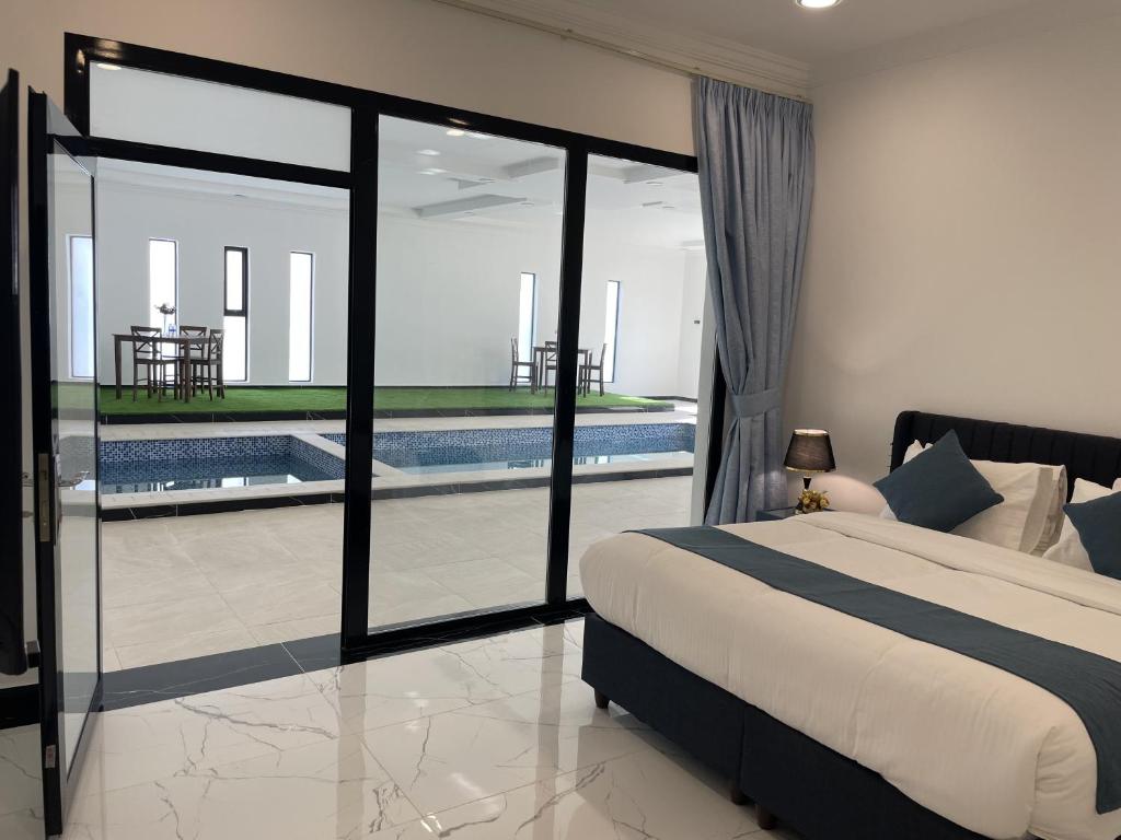 a bedroom with a bed and a swimming pool at Bedyiah Green Homes in Al Qābil