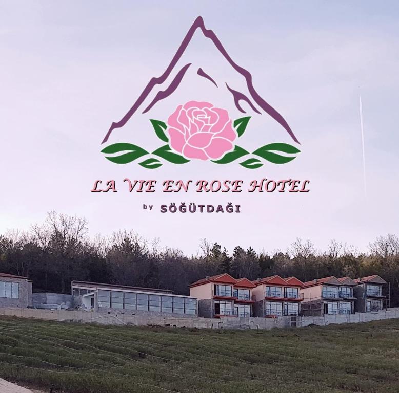 a sign that says la we get roses hotter at La Vie En Rose Hotel by Sogutdagi Isparta in Keçiborlu