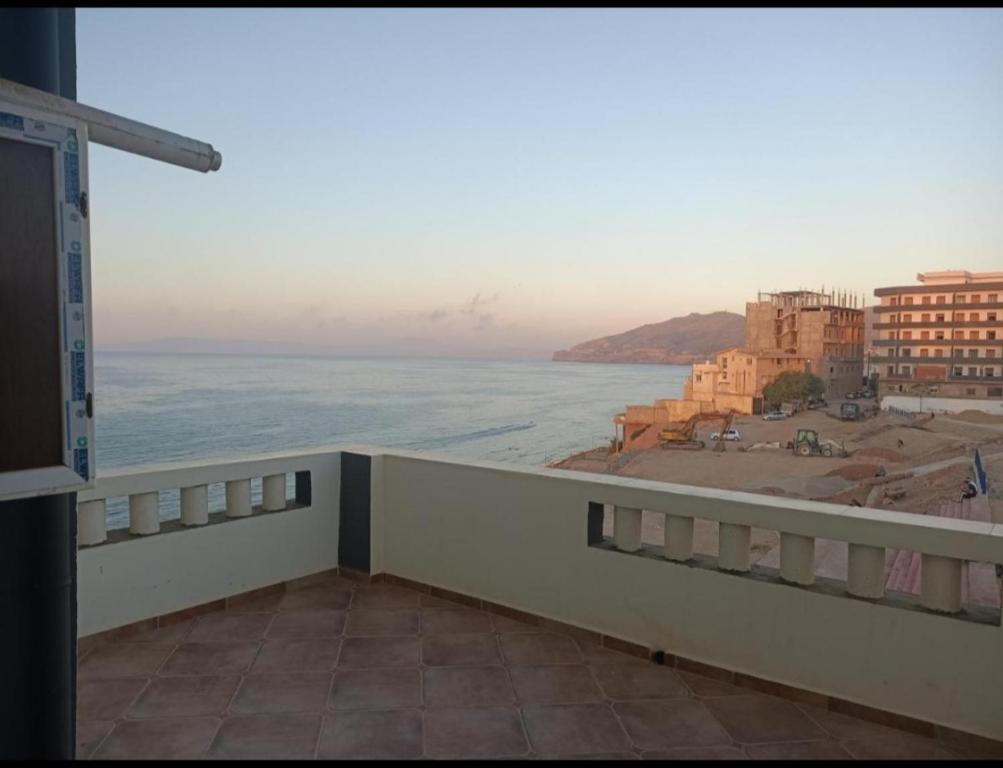 a view of the ocean from the balcony of a building at Résidence Amel in 'Aïn el Turk