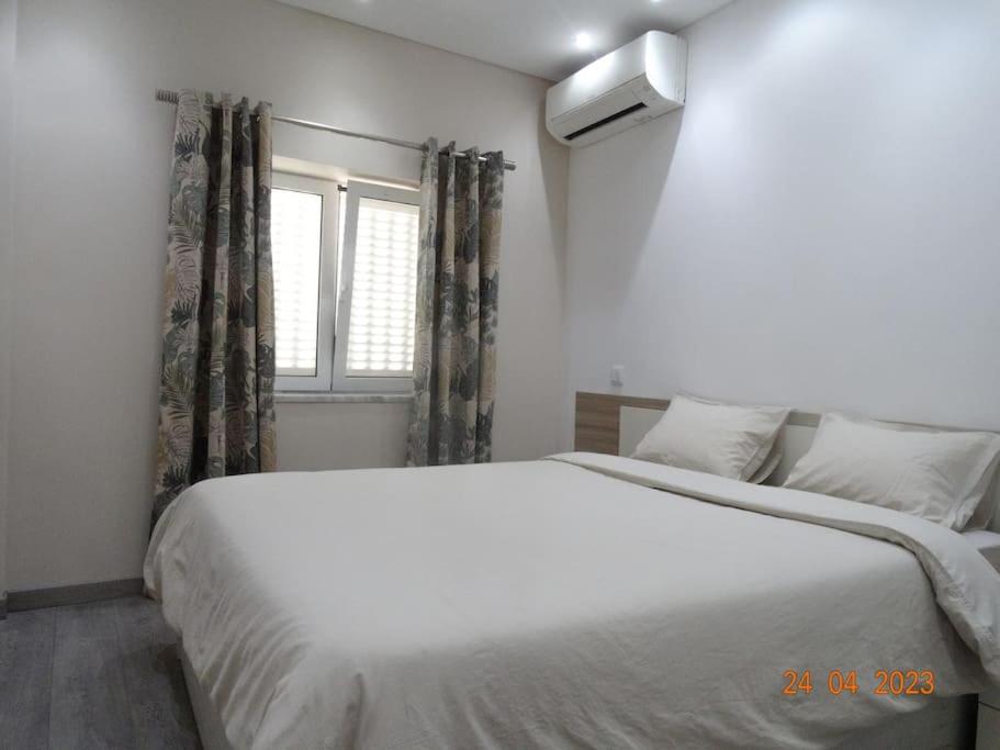 Cama ou camas em um quarto em Villa Andorinha
