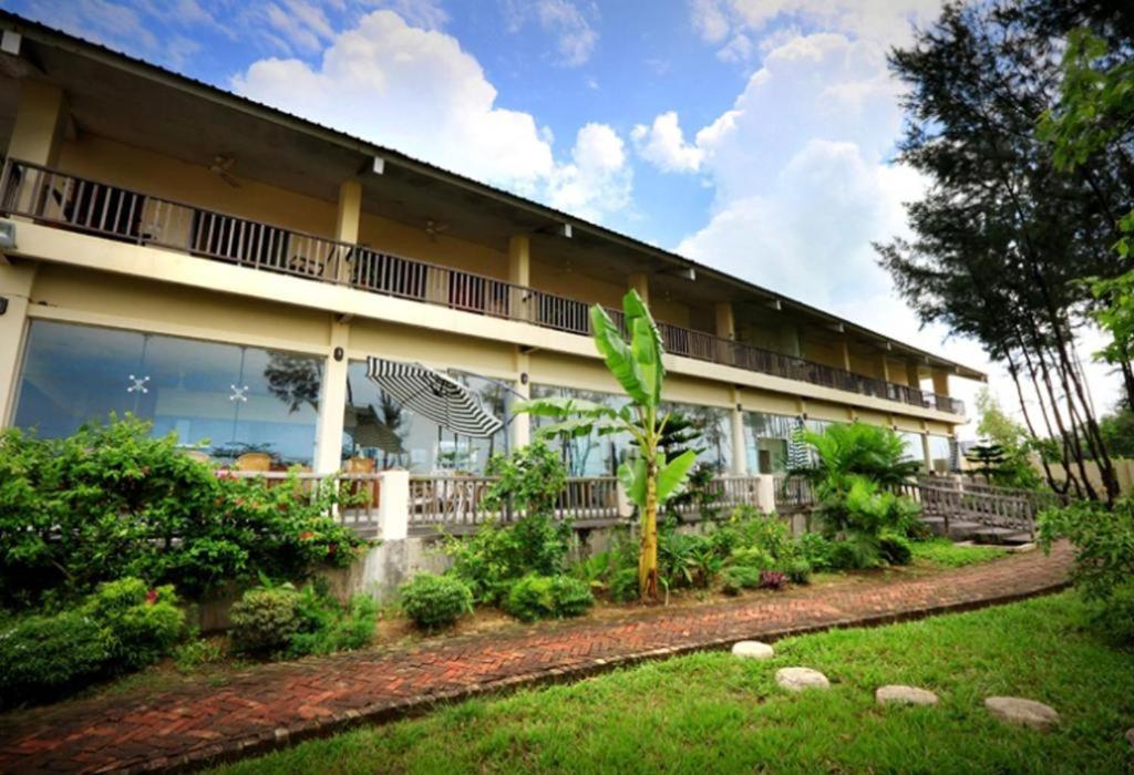 a building with a garden in front of it at Cox's Bazar Surf Club Resort & Cafe in Cox's Bazar