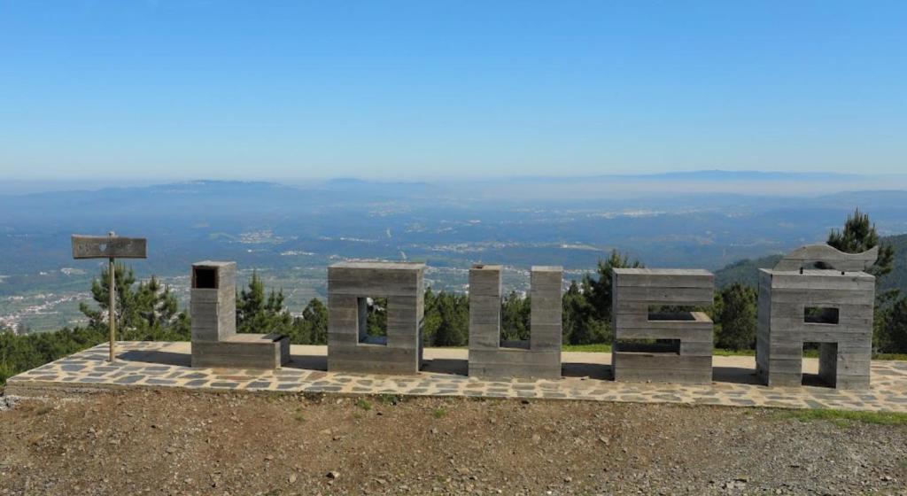 a monument on top of a hill with a view at Lousã Varandas House in Lousã