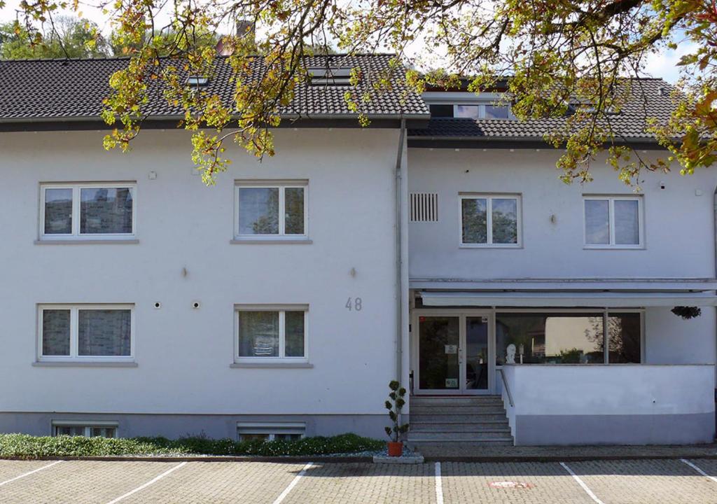 a white house with a lot of windows at Burghotel Lörrach in Lörrach