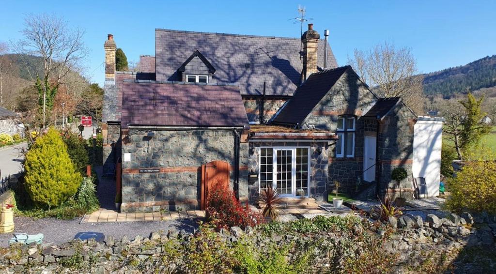 a large house with a stone at Chambers Apartment @ The Old Magistrates in Betws-y-coed