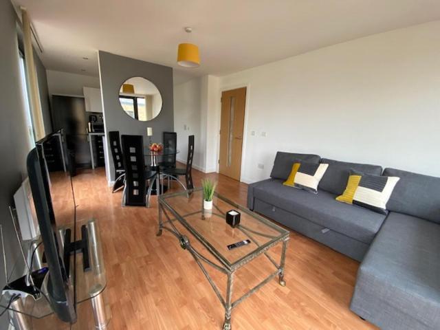 a living room with a couch and a table at Superb 1 Bedroom Serviced Apartment In City Centre in Birmingham