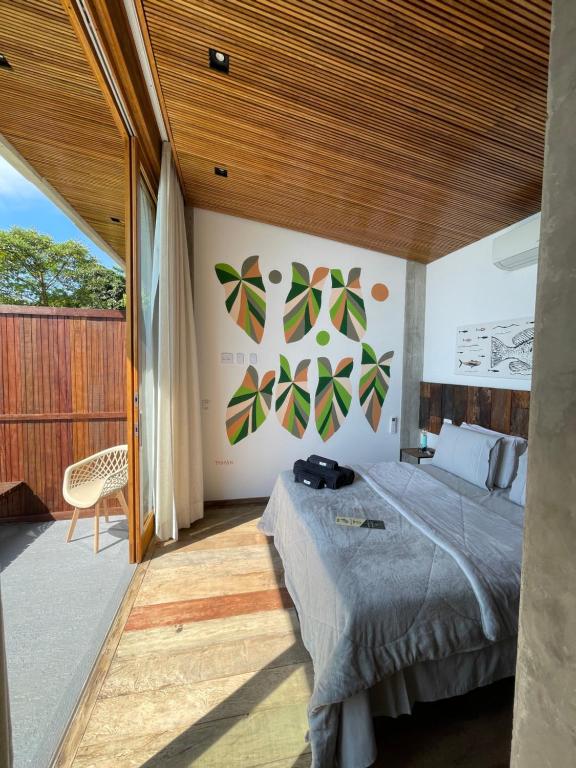 a bedroom with a bed and a wooden ceiling at Verde Mar Pousada in Angra dos Reis