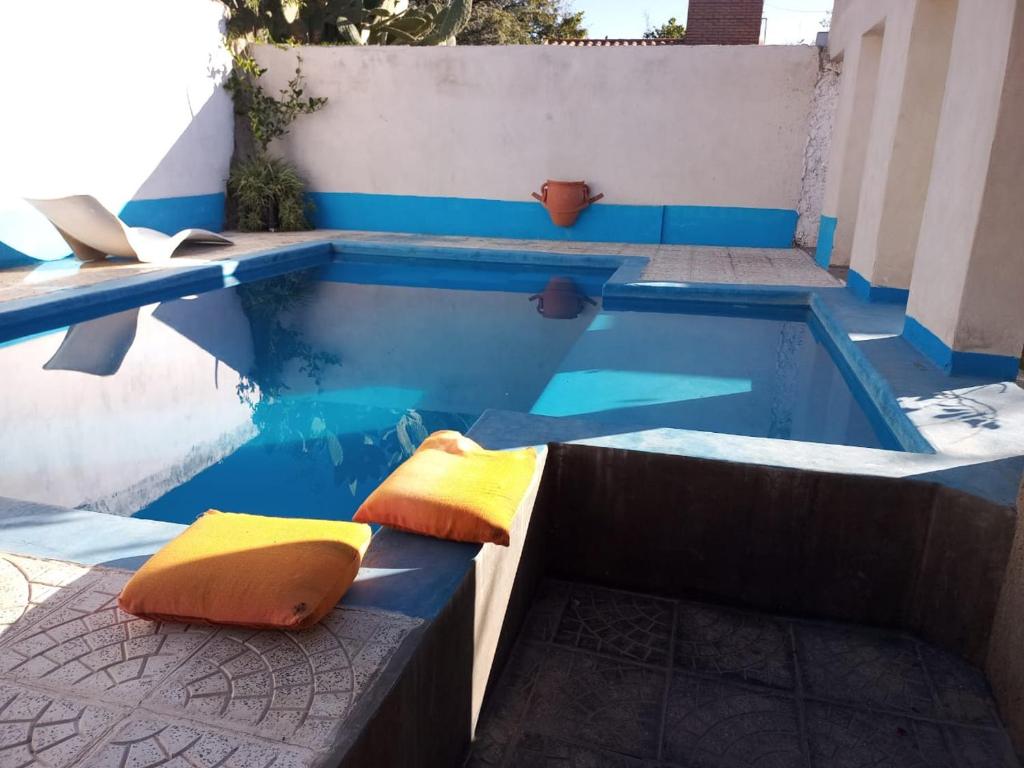 a swimming pool with two pillows in the water at ND nuestro destino in Cafayate
