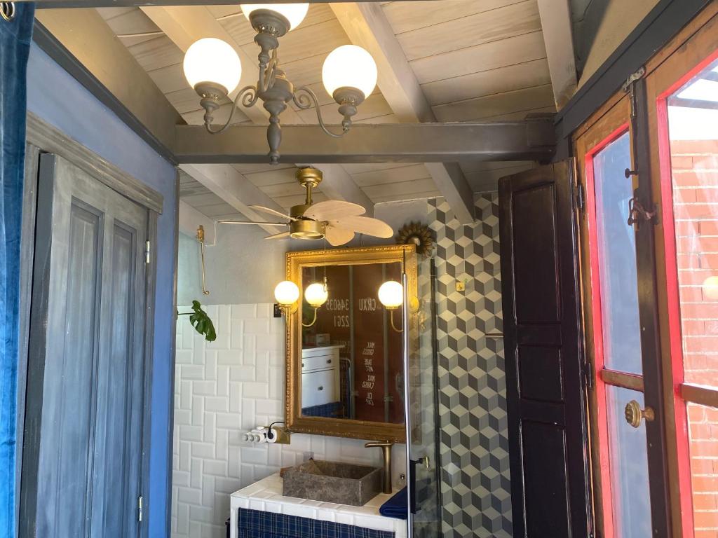 a bathroom with a sink and a mirror at Casa Rural Alfoz, -Tiny house- con patio privado, barbacoa, wifi, netflix, Aire acondicionado in Velliza