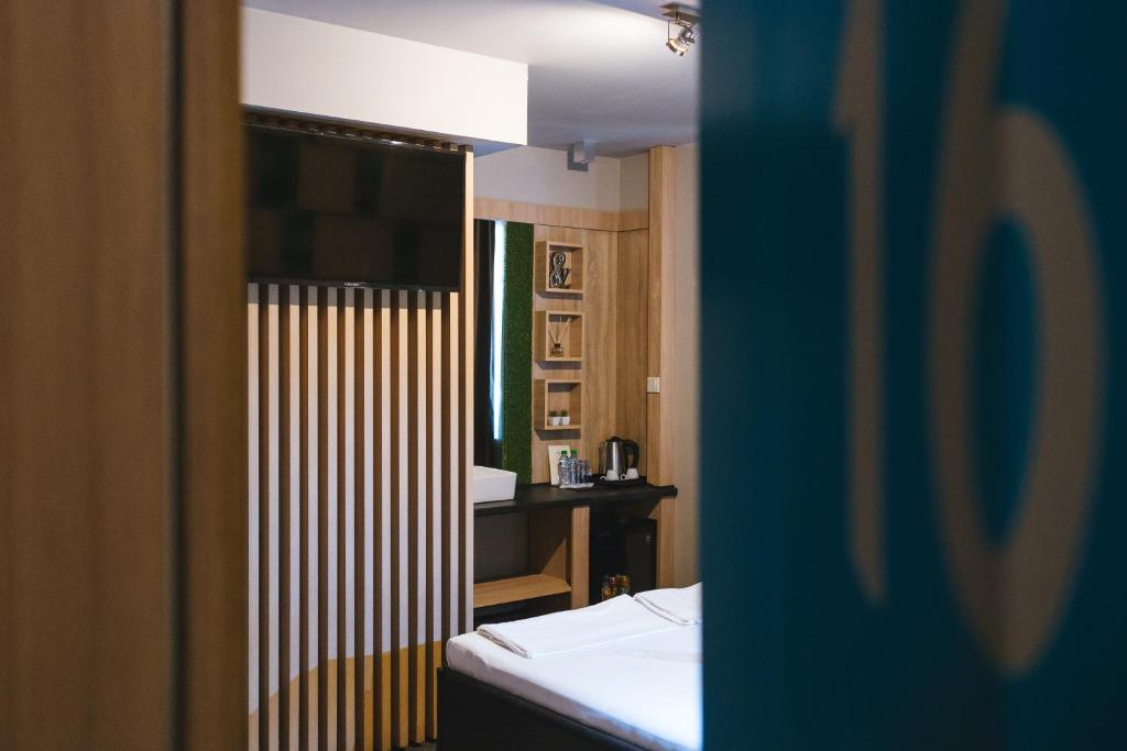 a view of a room with a bed and a mirror at Hotel Allur in Plovdiv