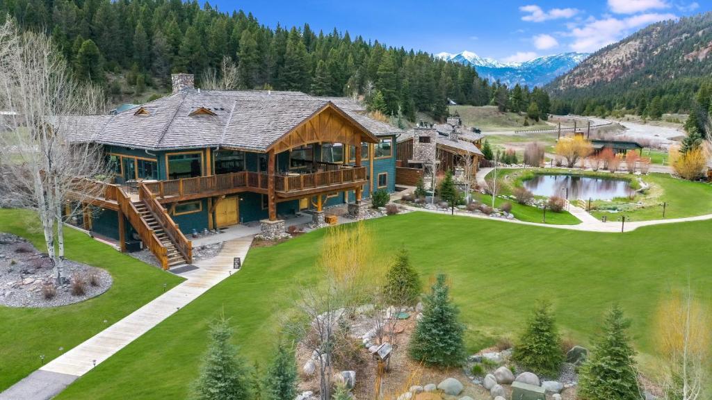 an aerial view of a large log home with a pond at Rainbow Ranch Lodge in Big Sky Canyon Village