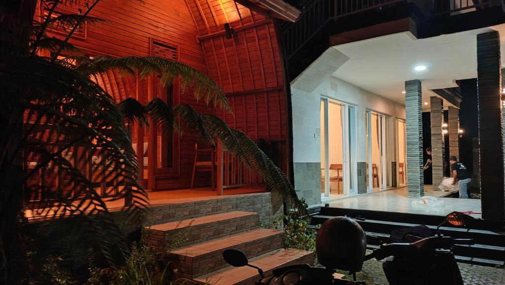 a room with stairs and a building with people in it at My Lodge Bedugul in Bedugul
