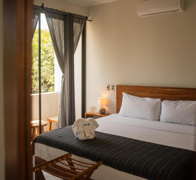 Postel nebo postele na pokoji v ubytování Hotel Muyu Tulum