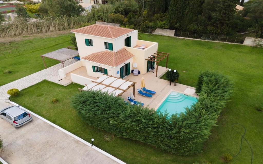 an aerial view of a house with a pool at Dafni (2 bedrooms, sleeps 4) in Sami