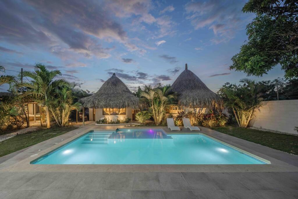 a swimming pool in front of a villa at Villa el Oasis, luxurious Santa Marta getaway in Santa Marta