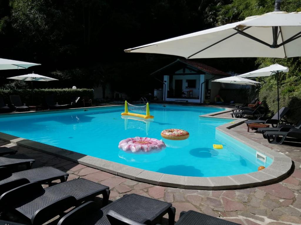a swimming pool with a slide in the middle at Agriturismo Villa Paradiso - appartamenti con piscina in Fauglia