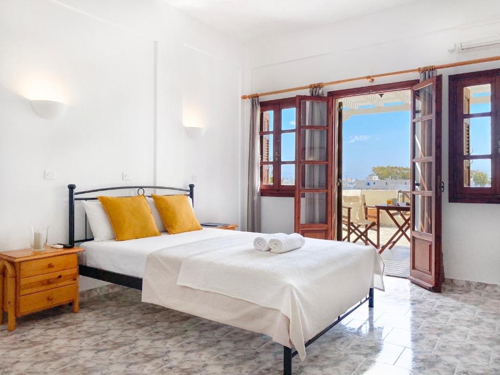 1 dormitorio con cama y vistas al océano en Almyra Villa, en Perissa