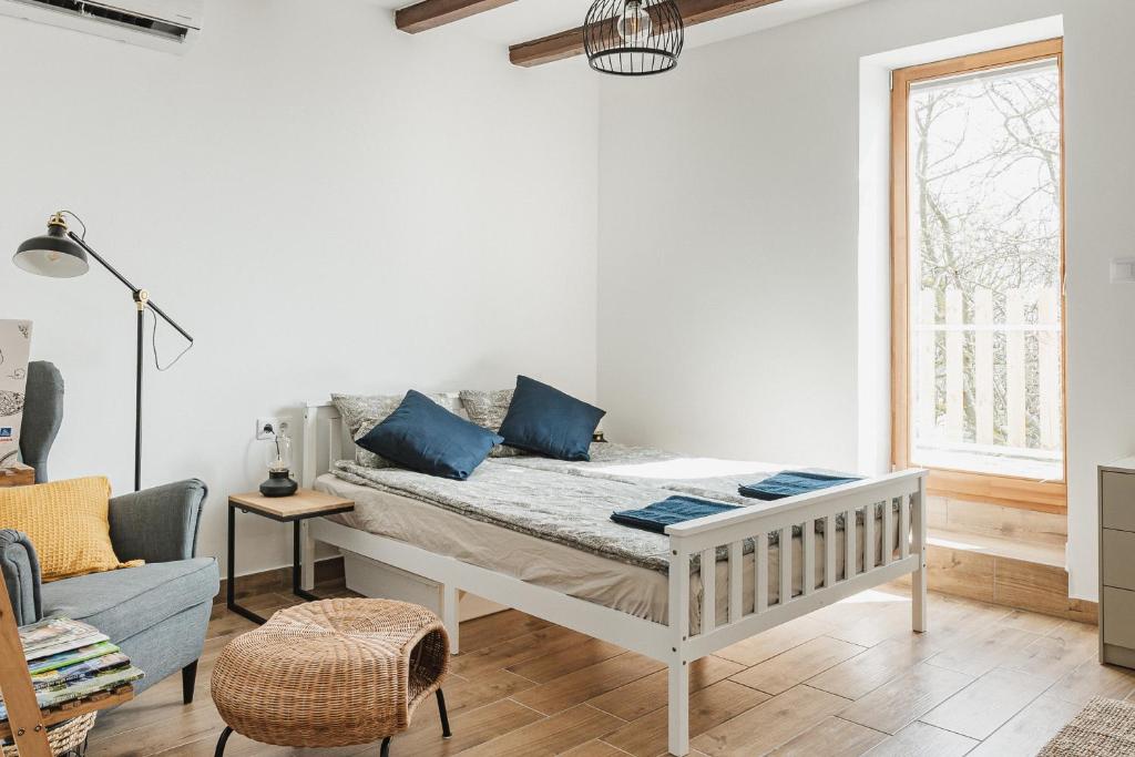 a bedroom with a bed with blue pillows on it at Barrique - Somló Country Home in Somlóvásárhely