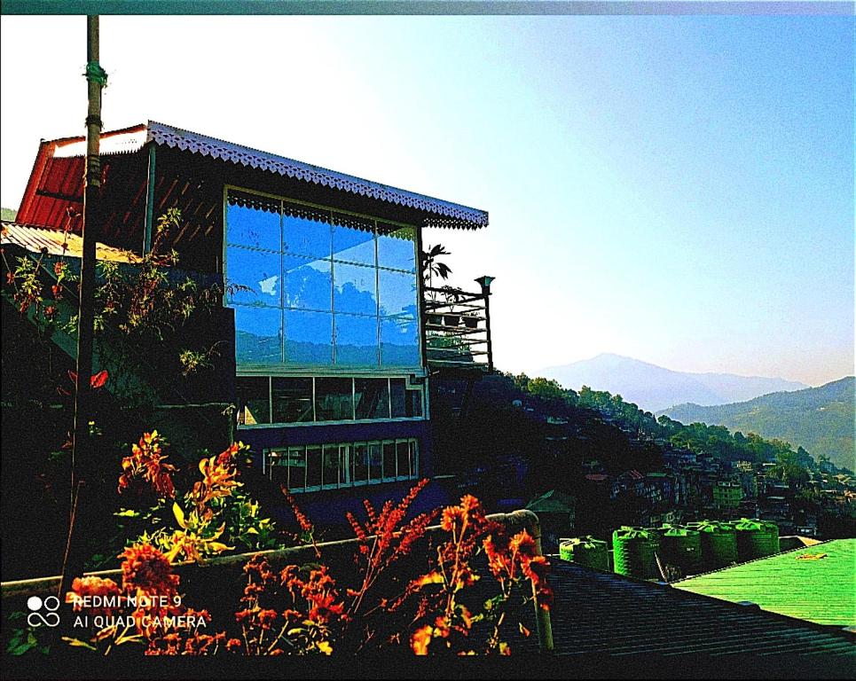 a building with a window on top of a mountain at Esses House A Luxury Homestay and service apartment in Gangtok