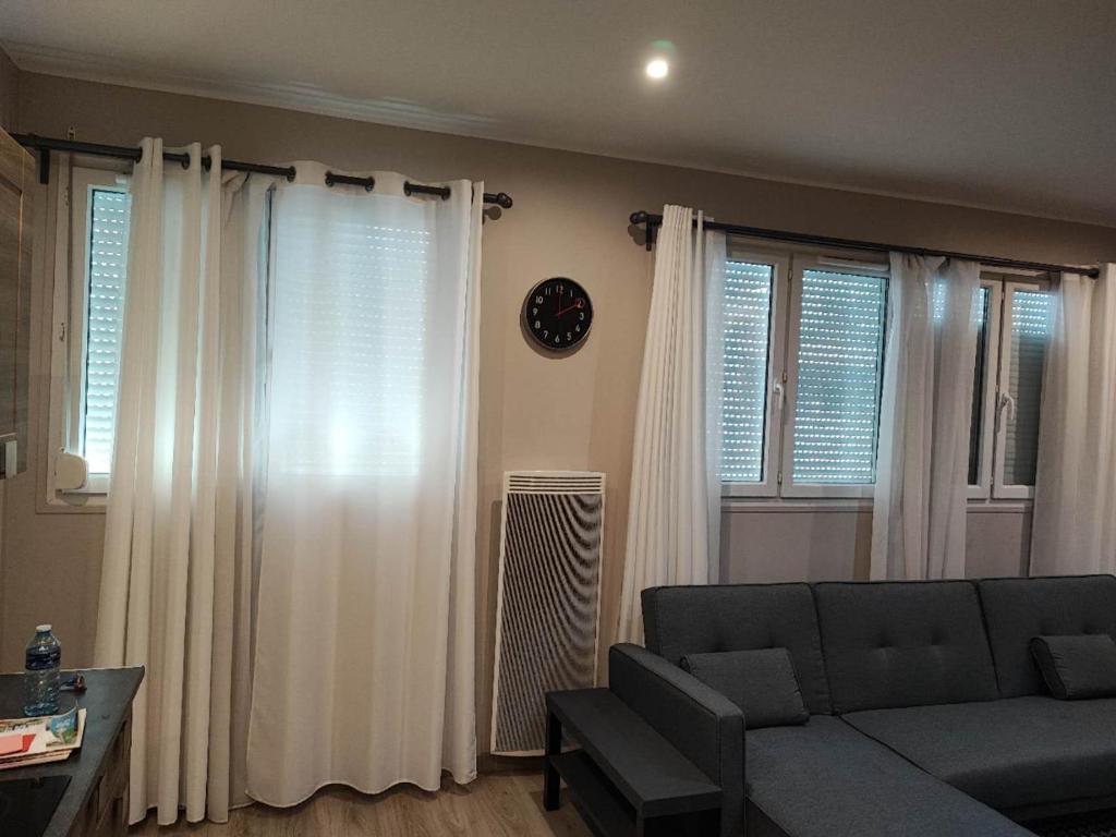a living room with white curtains and a couch at home, sweet home in Vitry-sur-Seine