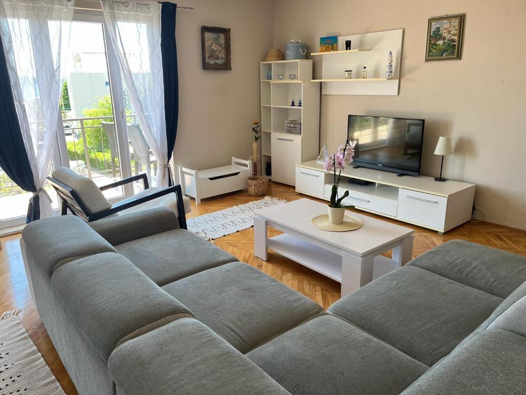 a living room with a couch and a tv at Apartment Frane in Kaštela