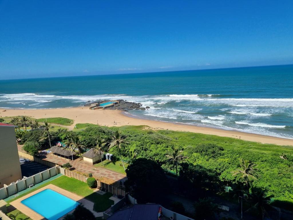 a view of the beach from the balcony of a house at Stella Maris 104 Amanzimtoti in Amanzimtoti