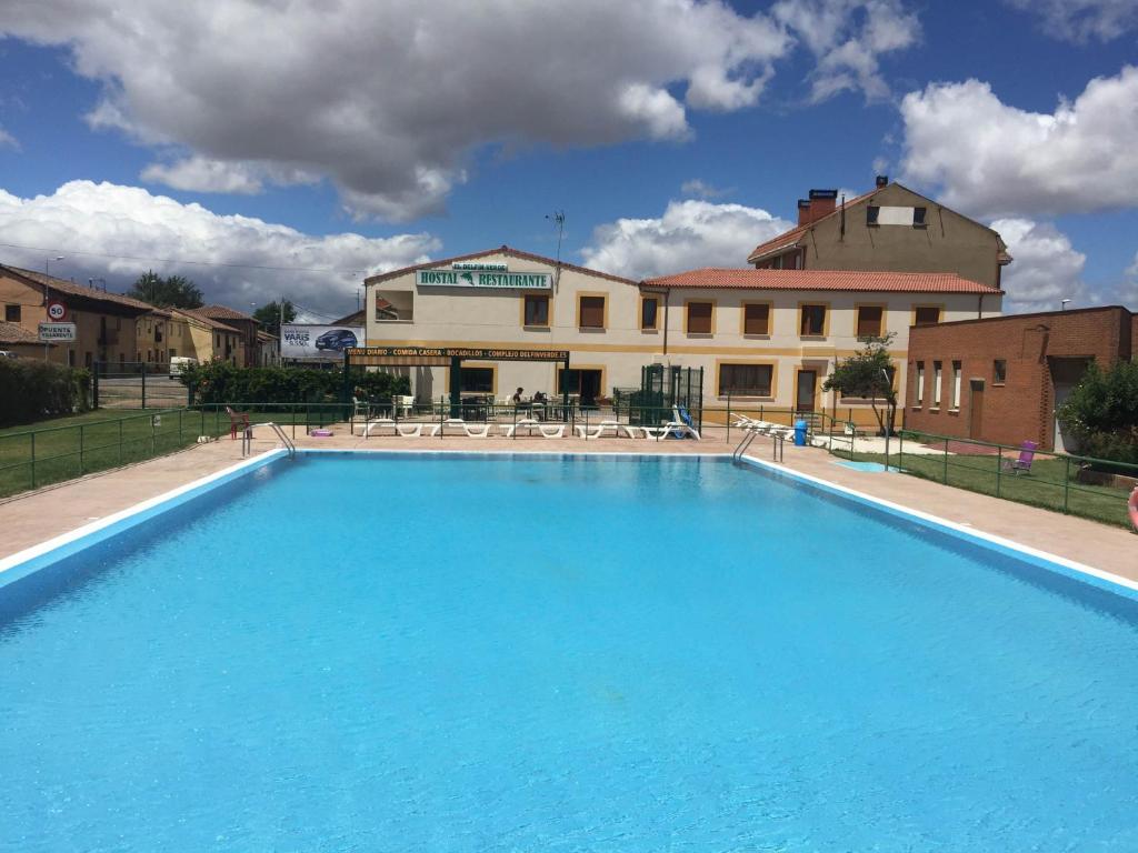 een groot blauw zwembad voor een gebouw bij EL DELFÍN VERDE in Villarente