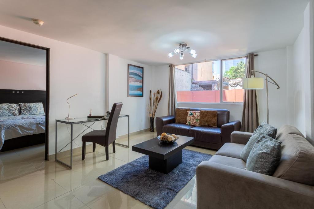 a living room with a couch and a table at Suites 259 Condesa in Mexico City