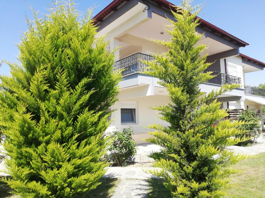 two trees in front of a house at My Erofili in Keramoti