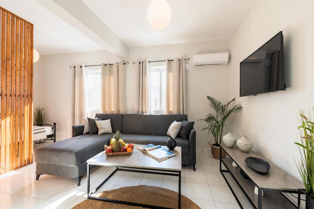 a living room with a couch and a table at Emelia Cozy Apartment in Rhodes Town