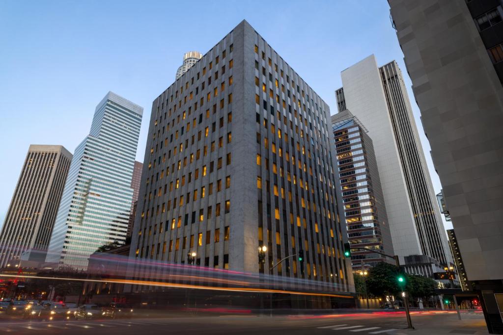 a tall building in the middle of a city at The Delphi Hotel in Los Angeles