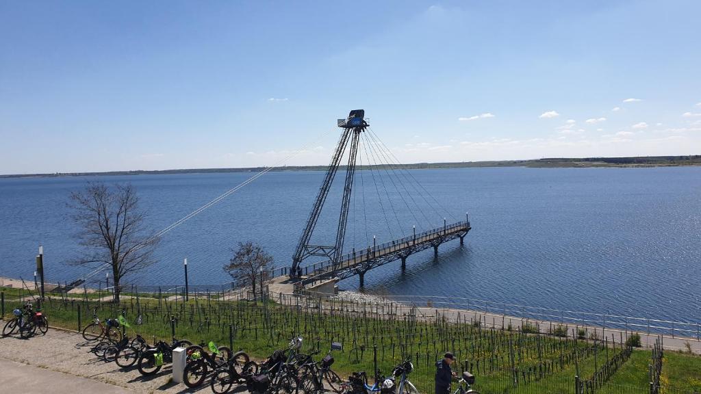 a bridge over a body of water with people on bikes at SeenSucht & Urlaubsträume, Ferienwohnung "Seeadler" in Großräschen