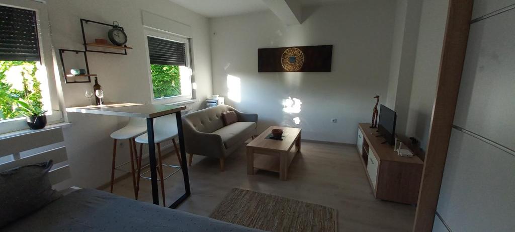 a small living room with a couch and a table at Apartman Jakša in Prijedor