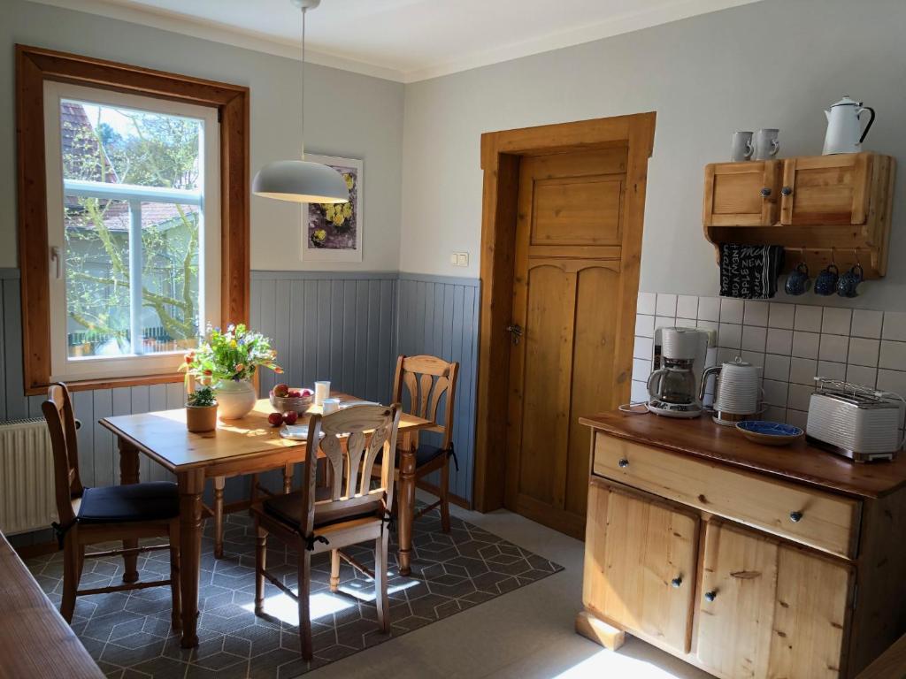 a kitchen with a wooden table and a dining room at Ferienwohnung Landlust 