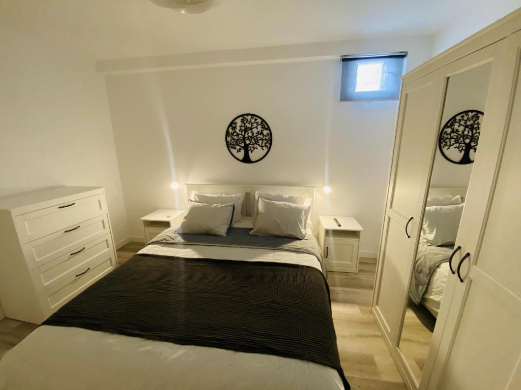 a small bedroom with a bed and a mirror at EL JORADO in Tamaduste
