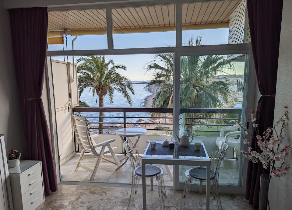 a room with a balcony with a table and chairs at LOFT CASTILLO SANTA CLARA Torremolinos in Torremolinos