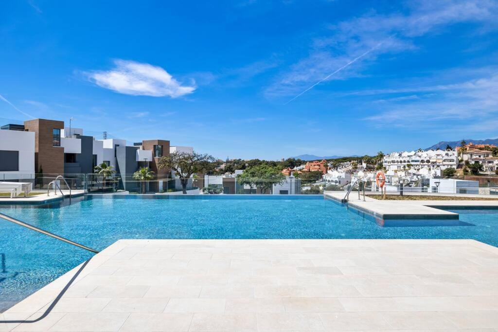 een groot zwembad bovenop een gebouw bij Luxury Apartment next to Golf Course in Marbella in Marbella