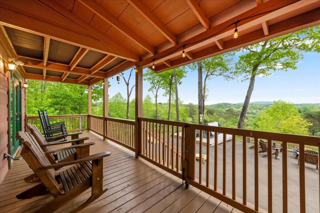 a porch with chairs and a view of the woods at Best Views in Ellijay - Waffle Bar-King Bed-HotTub in Ellijay