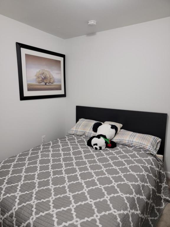 a bedroom with two stuffed pandas sitting on a bed at Cozy Peaceful B&B in Rosedale
