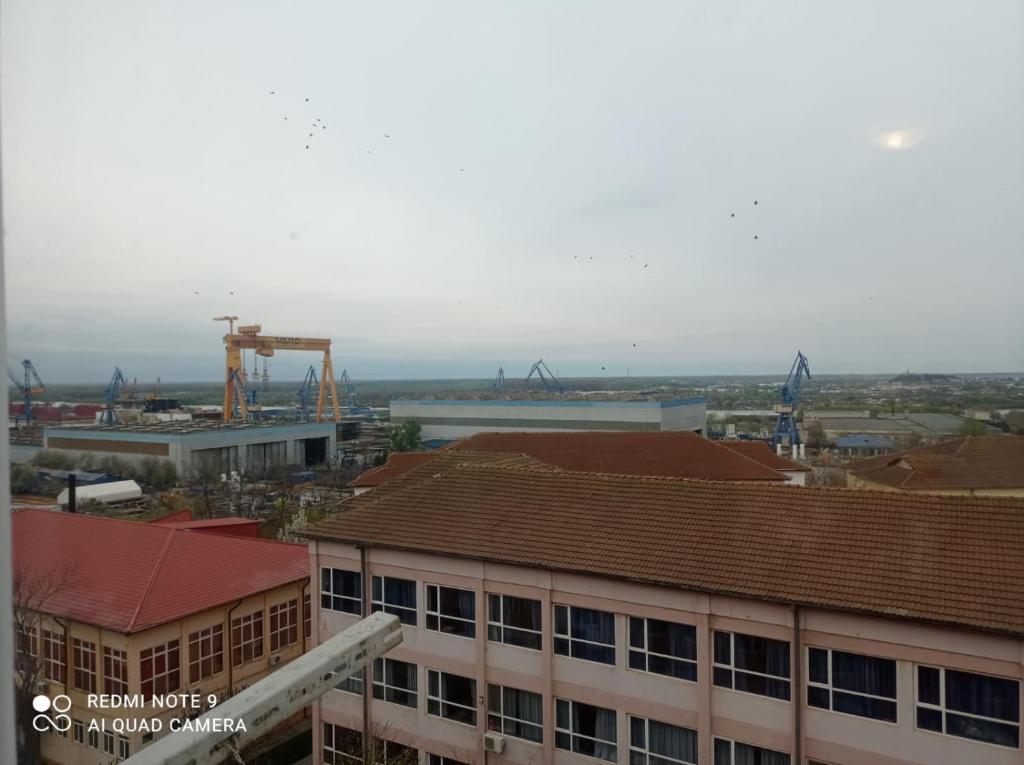 a view of a city with a crane and buildings at Garsoniera confort I in Tulcea