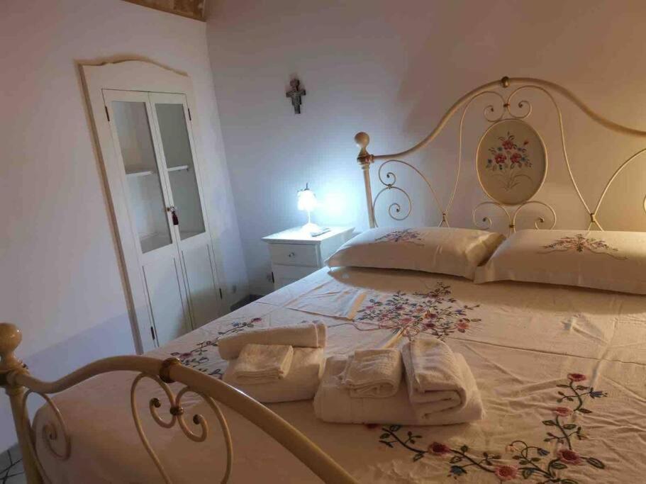 a bedroom with a bed with two towels on it at Casa Centro storico Gallipoli in Gallipoli