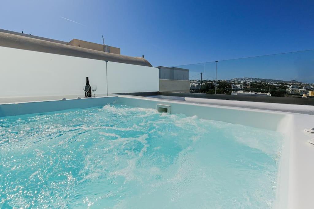 a swimming pool on the roof of a building at Ageri Suite in Vóthon