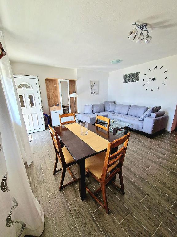 a living room with a table and a couch at Apartment MMP in Kotor