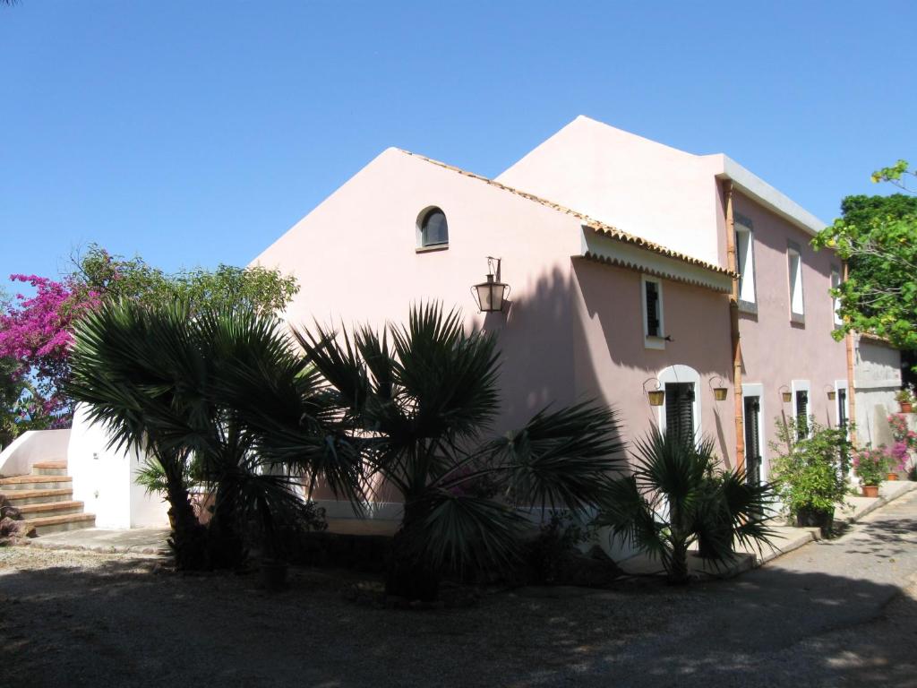 a house with a palm tree in front of it at Residence il Baglio in Porto San Giorgio