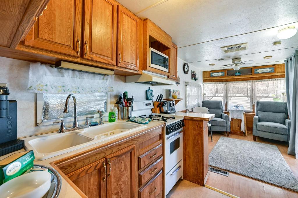 a kitchen with a sink and a stove at Yuma Getaway with Pool Access, 5 Mi to Lutes Casino! in Yuma